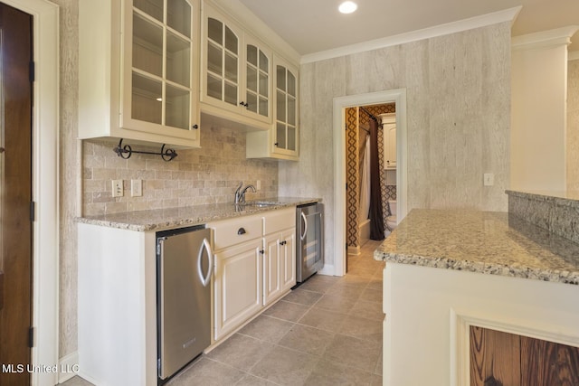 kitchen with freestanding refrigerator, light stone counters, beverage cooler, glass insert cabinets, and light tile patterned floors