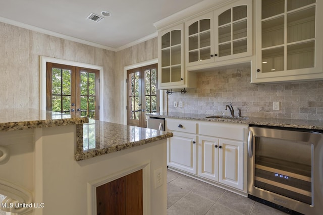 kitchen featuring french doors, a sink, visible vents, light tile patterned flooring, and wine cooler