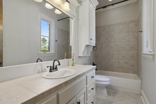bathroom featuring tile patterned floors, toilet, vanity, and shower / bathtub combination