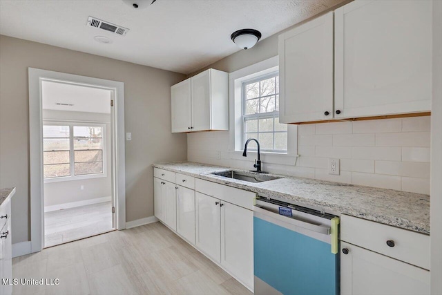 127 Autumn Dr, Vicksburg, MS 39180 - kitchen featuring visible vents, decorative backsplash, dishwasher, white cabinetry, and a sink
