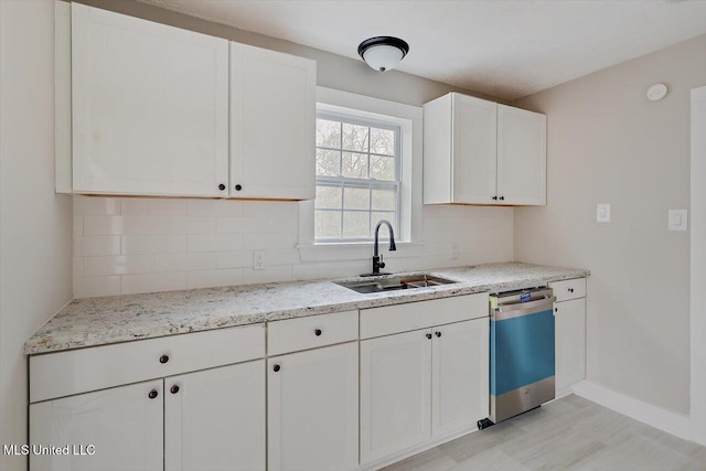 127 Autumn Dr, Vicksburg, MS 39180 - kitchen featuring decorative backsplash, dishwashing machine, light stone counters, white cabinetry, and a sink