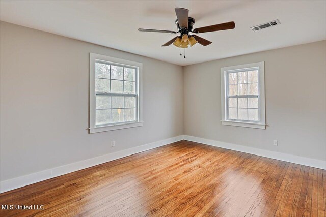 127 Autumn Dr, Vicksburg, MS 39180 - unfurnished room with visible vents, ceiling fan, baseboards, and hardwood / wood-style flooring