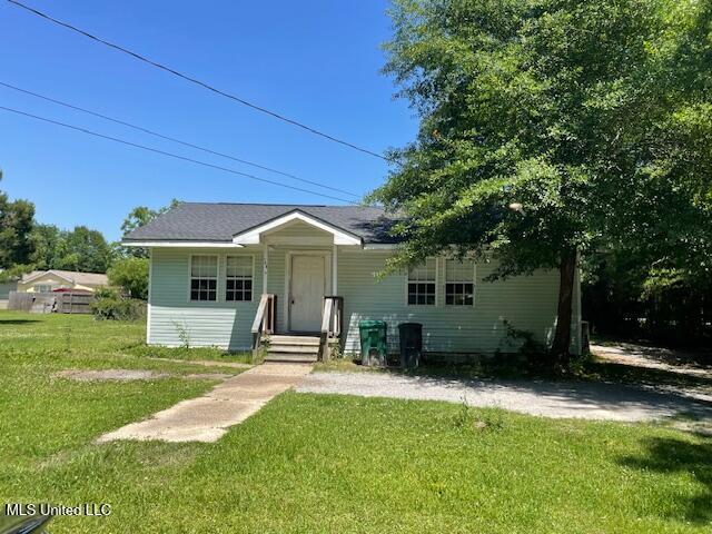 708 Wood St, Waveland, MS 39576 - view of front of home with a front yard