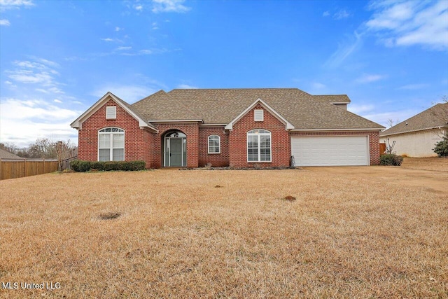 view of front of home with a garage and a front lawn