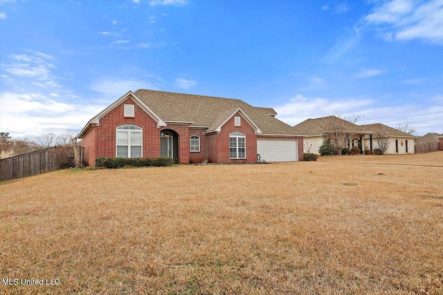 single story home featuring a garage and a front lawn