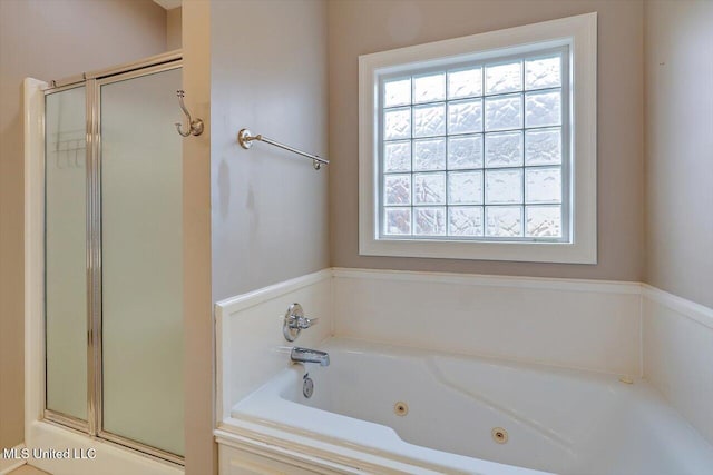 bathroom featuring independent shower and bath