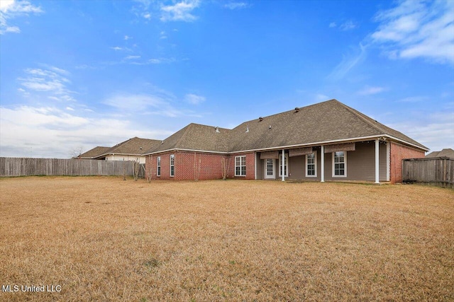 rear view of house with a yard