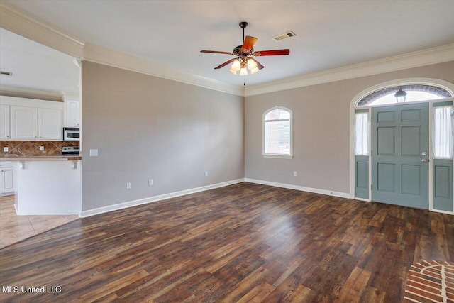 interior space featuring dark wood-type flooring, ceiling fan, and ornamental molding