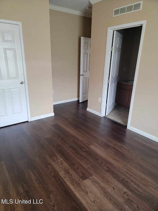 unfurnished room featuring crown molding, baseboards, visible vents, and dark wood-type flooring