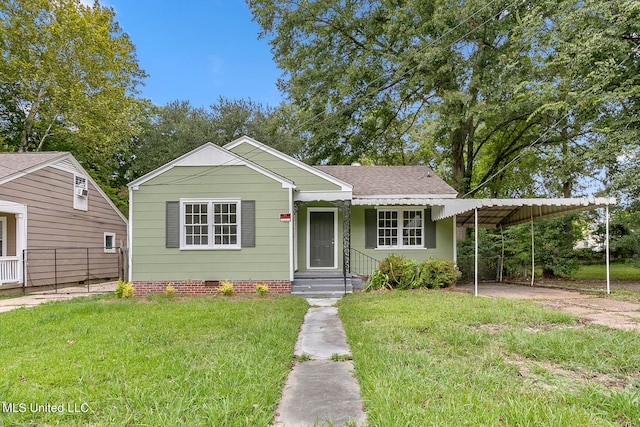 bungalow featuring a front lawn and a carport