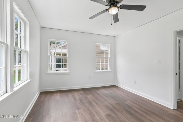 spare room with ceiling fan and dark hardwood / wood-style flooring