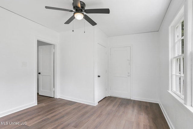 spare room featuring ceiling fan and dark hardwood / wood-style floors