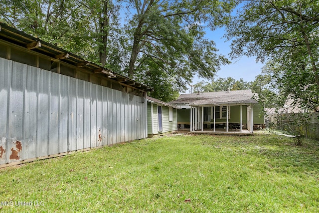 exterior space featuring a lawn and a sunroom