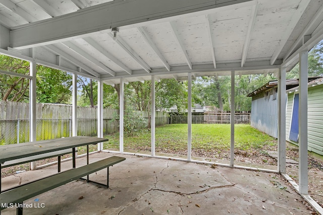 unfurnished sunroom with vaulted ceiling