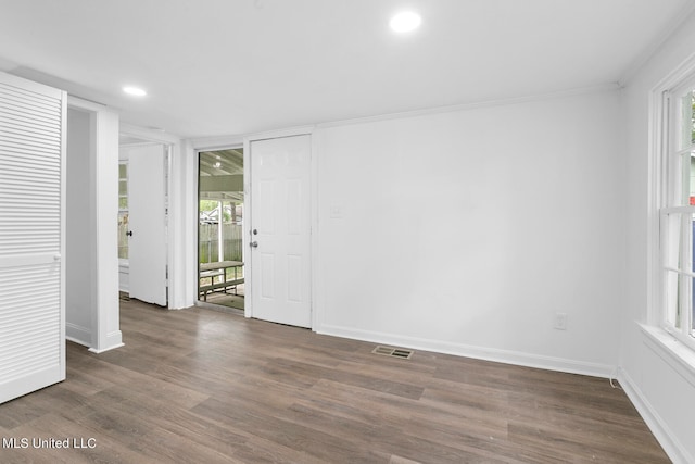 unfurnished room with crown molding and dark hardwood / wood-style floors