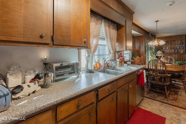 kitchen with dishwasher, sink, and pendant lighting