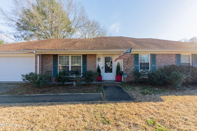 single story home with a garage and a front yard