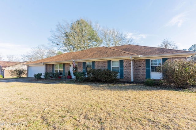 ranch-style house featuring a garage and a front lawn