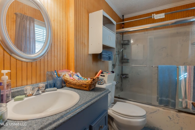 full bathroom with toilet, crown molding, a textured ceiling, vanity, and enclosed tub / shower combo