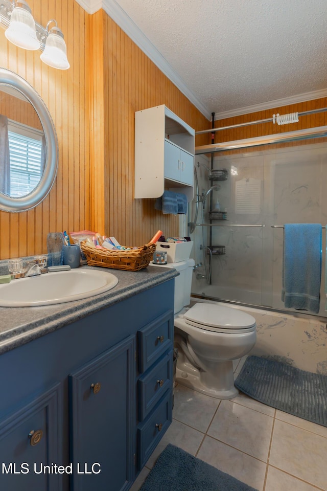 full bathroom with tile patterned floors, shower / bath combination with glass door, a textured ceiling, ornamental molding, and vanity