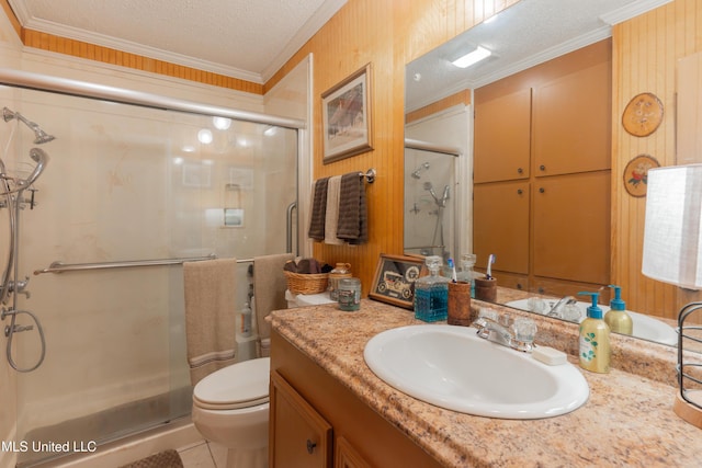 bathroom featuring vanity, toilet, a shower with shower door, and a textured ceiling