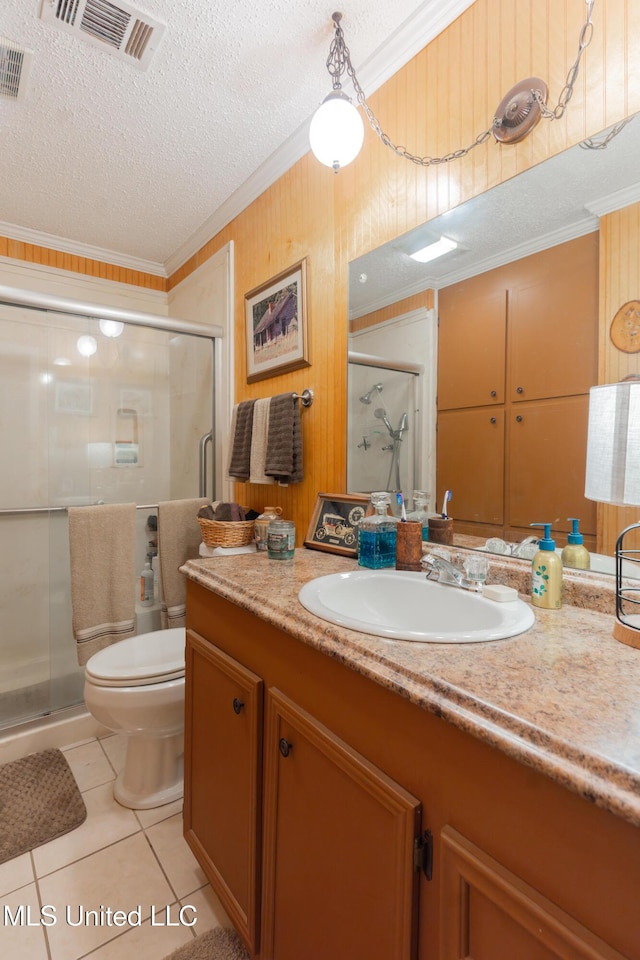 bathroom with tile patterned flooring, crown molding, a shower with door, and a textured ceiling