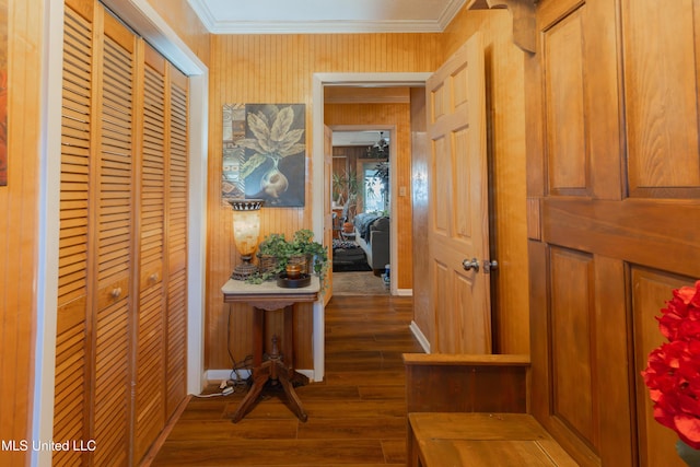 hall with ornamental molding and dark hardwood / wood-style flooring