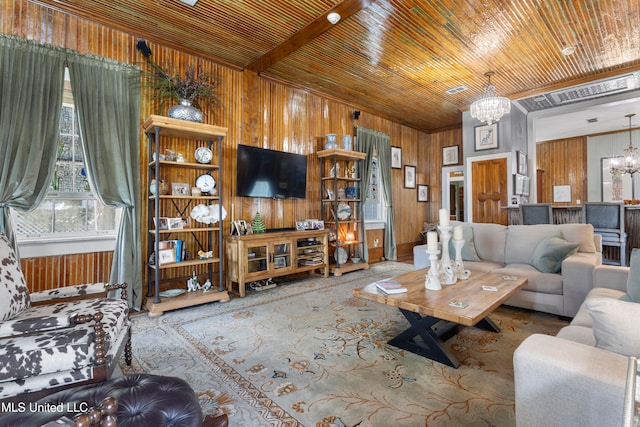 living room with wooden walls, wood ceiling, and an inviting chandelier