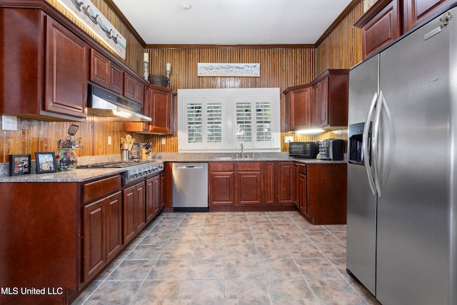 kitchen featuring sink, appliances with stainless steel finishes, and light stone counters