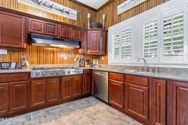 kitchen featuring light stone counters, appliances with stainless steel finishes, sink, and ornamental molding