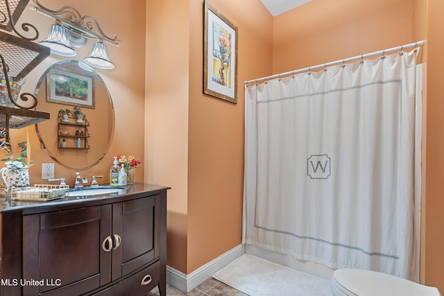 bathroom featuring vanity, toilet, tile patterned floors, and a shower with curtain