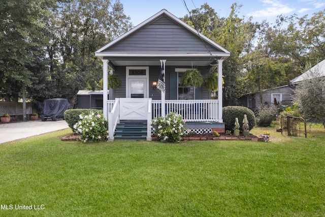 bungalow with a porch and a front lawn