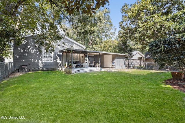 back of house featuring a yard and a patio area