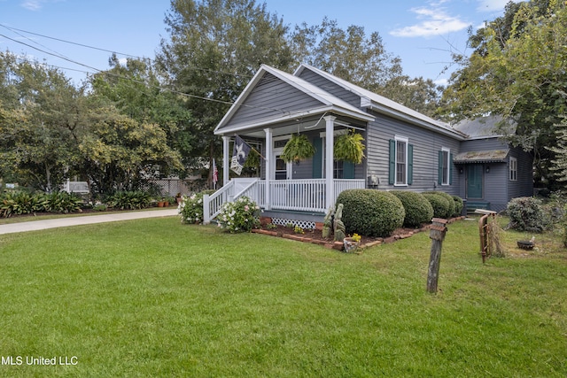 view of side of property featuring a porch and a yard