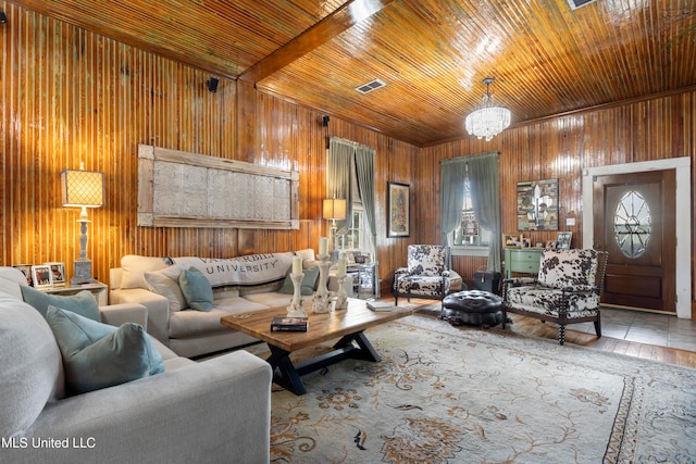 living room featuring wood ceiling, tile patterned flooring, an inviting chandelier, and wood walls