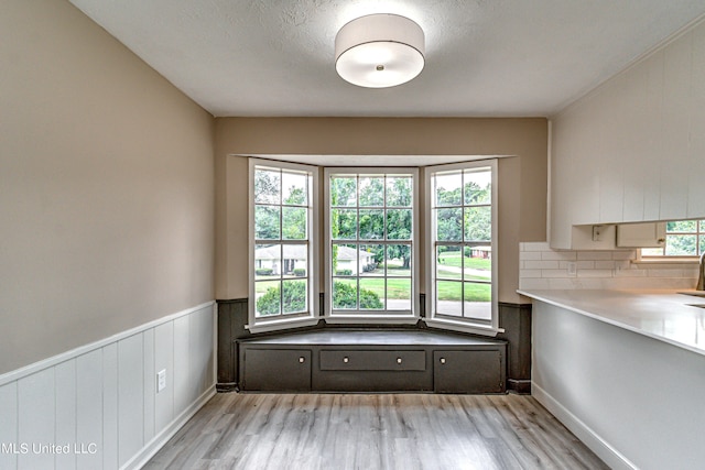 unfurnished dining area featuring a healthy amount of sunlight and light hardwood / wood-style flooring