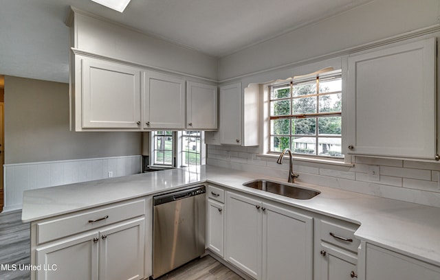 kitchen featuring dishwasher, white cabinets, sink, and light wood-type flooring