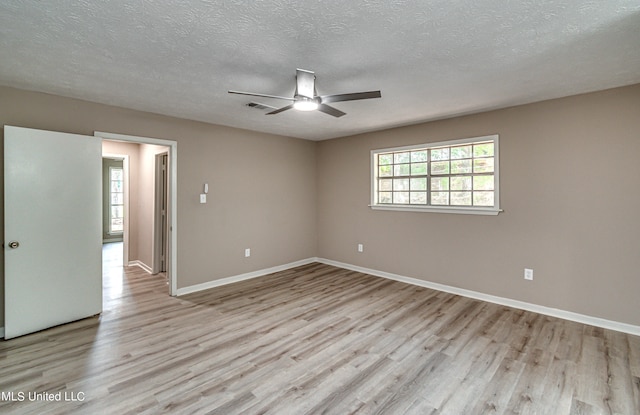 unfurnished room featuring light hardwood / wood-style floors, a textured ceiling, and ceiling fan