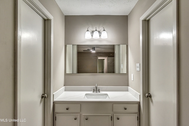 bathroom featuring vanity and a textured ceiling