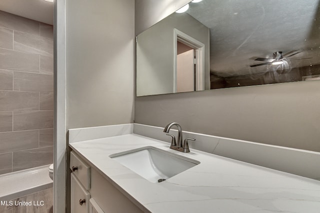 bathroom with vanity, toilet, and ceiling fan