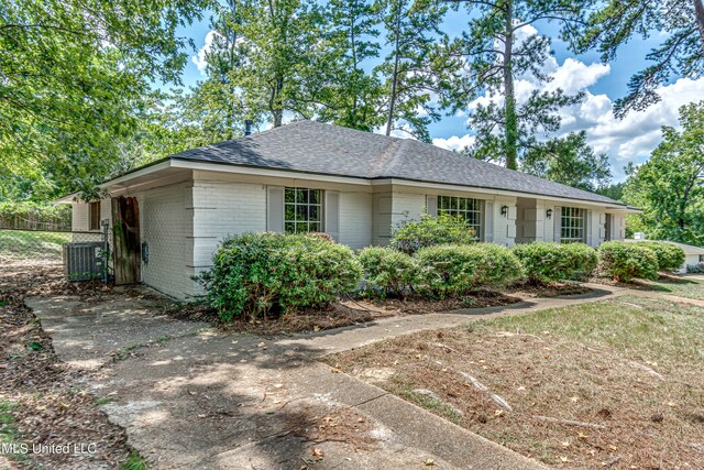 ranch-style home featuring cooling unit