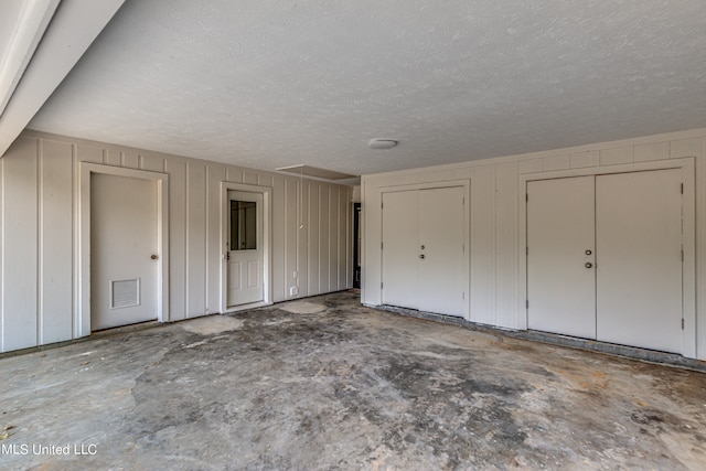 interior space featuring multiple closets and a textured ceiling