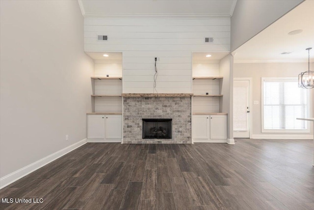 unfurnished living room with visible vents, ornamental molding, a fireplace, baseboards, and dark wood-style floors