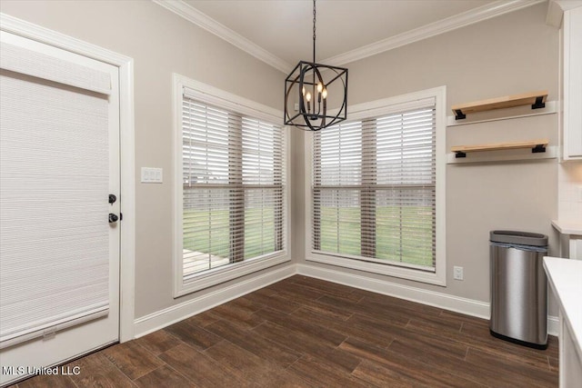 unfurnished dining area with crown molding, baseboards, an inviting chandelier, and dark wood finished floors