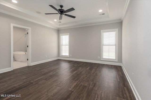 spare room with baseboards, visible vents, ornamental molding, and dark wood finished floors