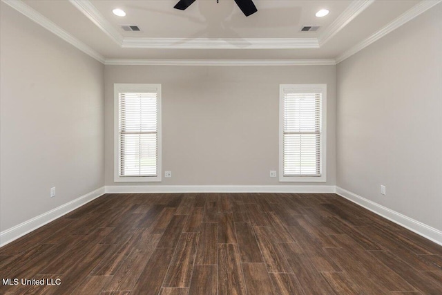 spare room with visible vents, a raised ceiling, and a wealth of natural light