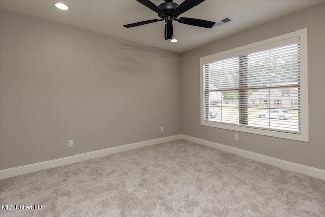 carpeted spare room featuring baseboards, a ceiling fan, and recessed lighting