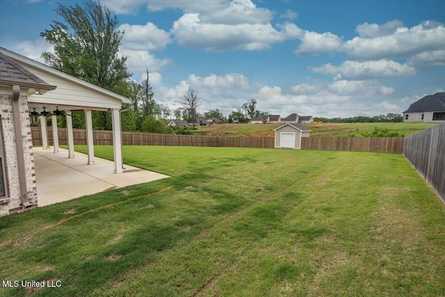 view of yard featuring a patio, an outbuilding, a shed, and a fenced backyard