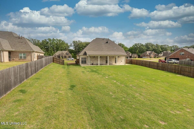 view of yard with a fenced backyard, a patio, and a residential view