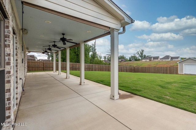 view of patio / terrace with an outdoor structure, a fenced backyard, a ceiling fan, and a storage shed